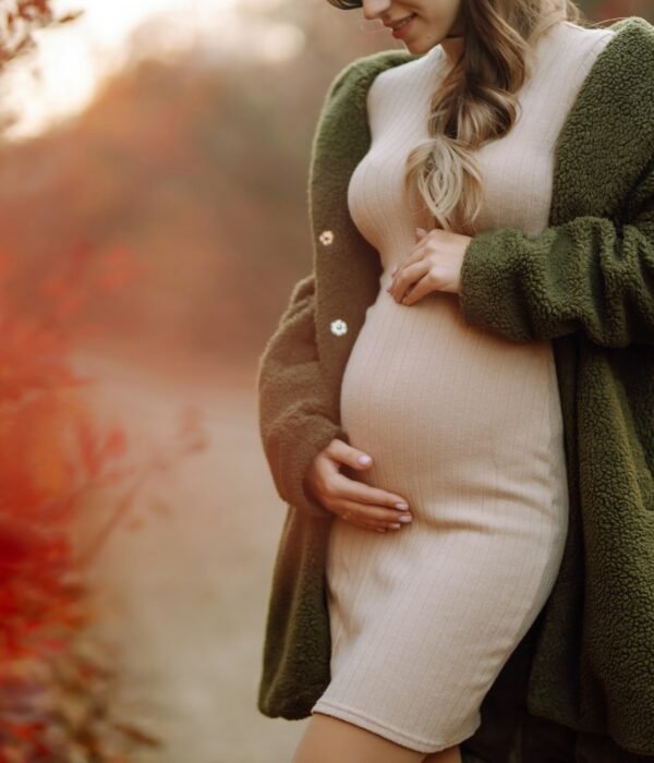 Beautiful pregnant woman feeling lovely in the park. Motherhood. Maternity. Lifestyle concept.