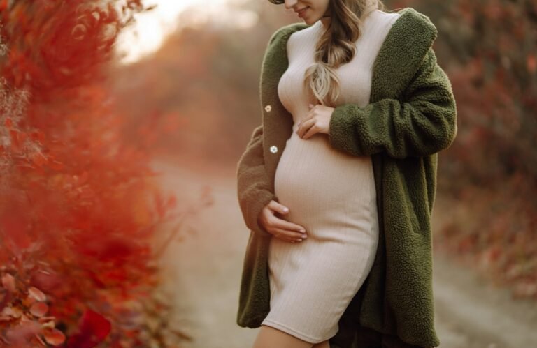 Beautiful pregnant woman feeling lovely in the park. Motherhood. Maternity. Lifestyle concept.