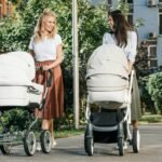 mothers walking with baby strollers on street