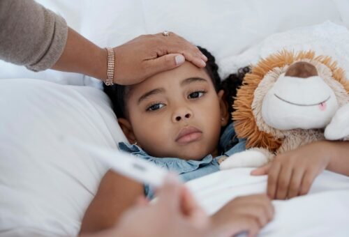 Sick child, covid and medical emergency in bed of home, healthcare problem in bedroom of house and