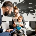 Woman and baby boy with travel agent at the office