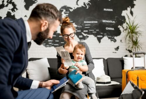 Woman and baby boy with travel agent at the office