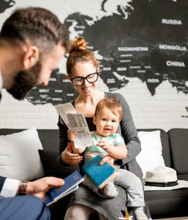 Woman and baby boy with travel agent at the office