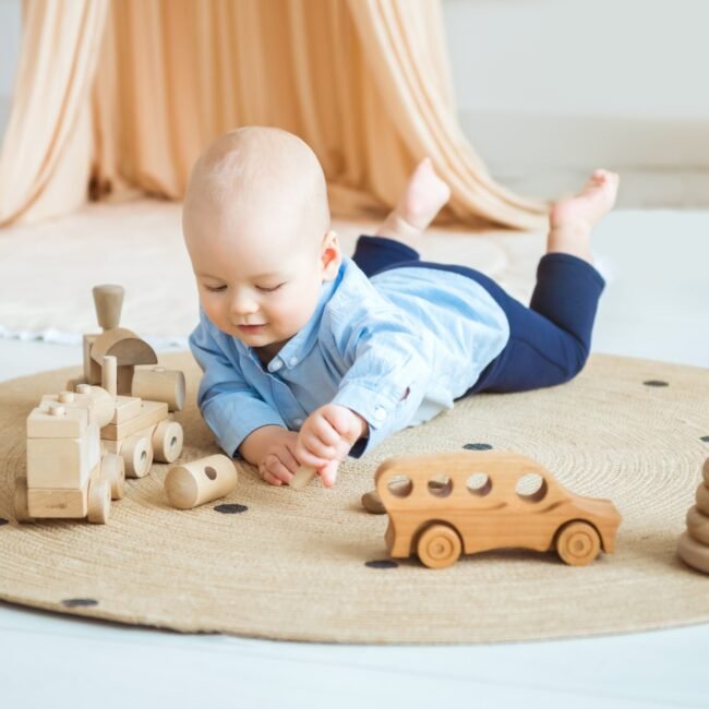 Baby playing with wooden toys. Eco-friendly wooden toys for children